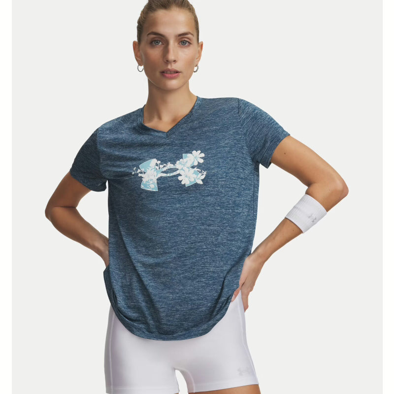 Woman wearing a blue athletic shirt with a floral design on a white background. Willapa Outdoor