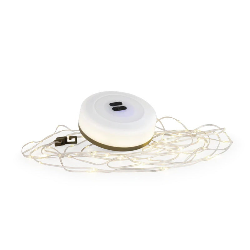 White electronic device with string lights on a white background