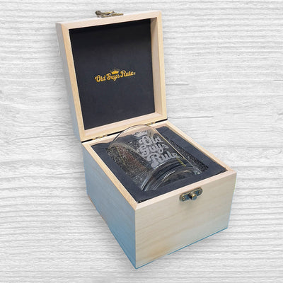 Wooden box with a glass inside, featuring the 'Old Fashioned' logo on a textured white background.