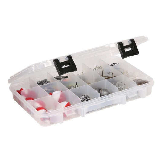 Clear plastic tackle box with various fishing lures on a white background