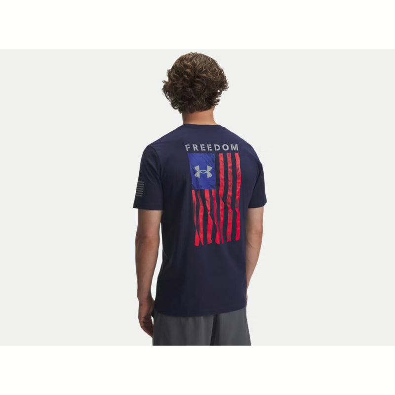 Person wearing a navy blue t-shirt with an American flag and 'Freedom' text on the back, on a white background. Willapa Outdoor
