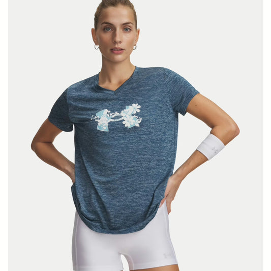 Woman wearing a blue athletic shirt with a floral design on a white background. Willapa Outdoor