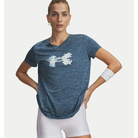 Woman wearing a blue athletic shirt with a floral design on a white background. Willapa Outdoor